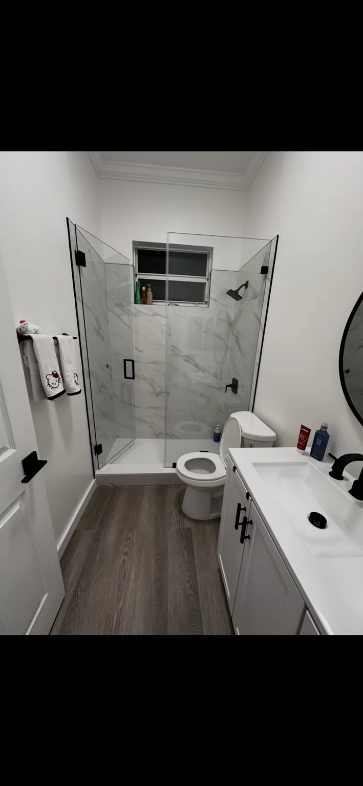 Remodeled bathroom with glass shower enclosure